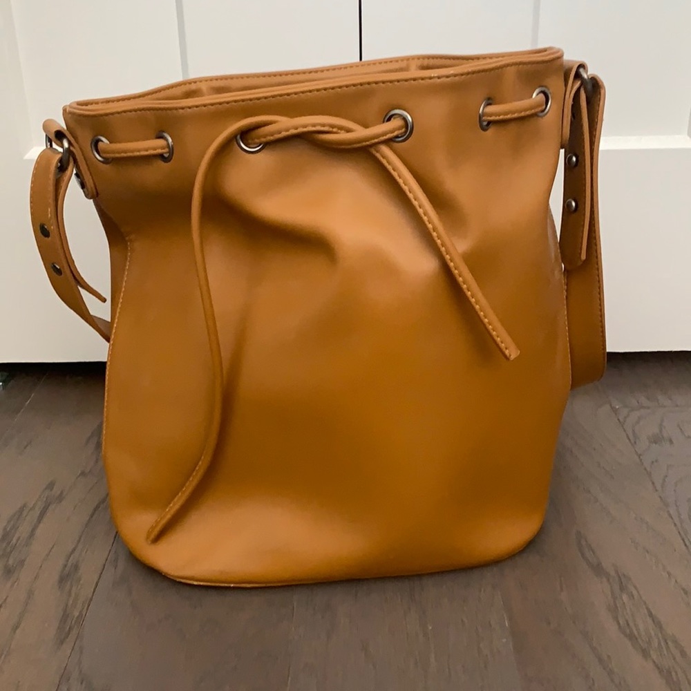 Faux leather tan bucket bag.
